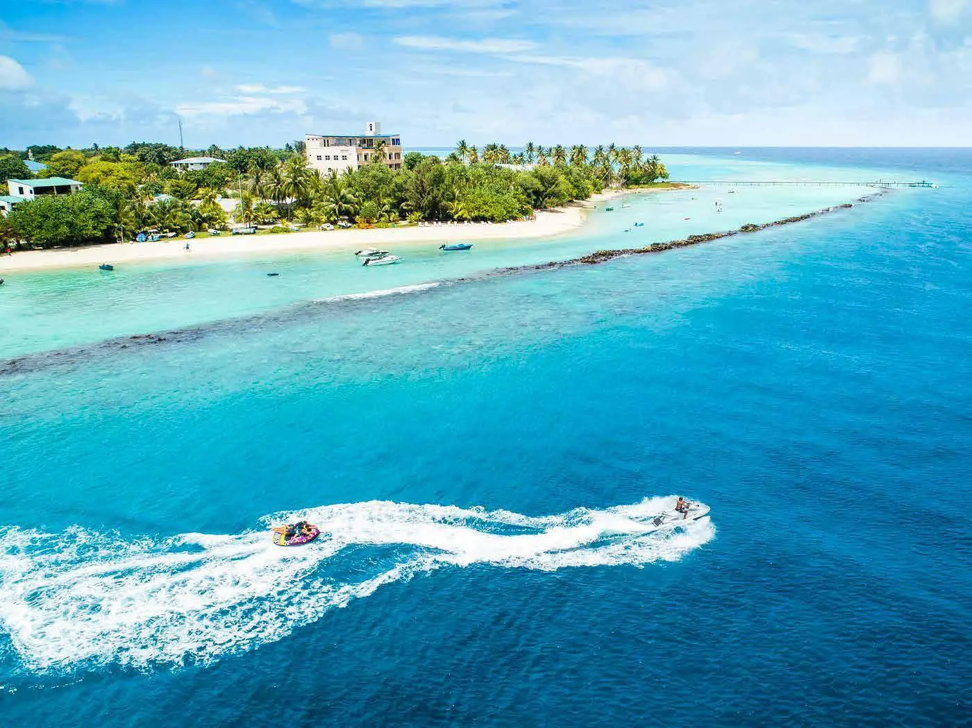Aerial view of Thulusdhoo's beach, reef and lagoon